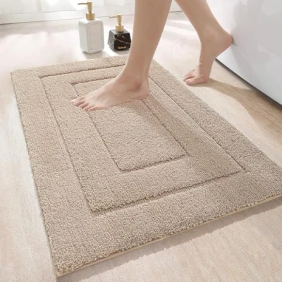 Abbildung von DEXI Badteppich rutschfeste,weicher Badezimmerteppich Wasserabsorbierend Badematte maschinenwaschbar Badvorleger für Dusche,Badewanne und Toilette Beige,60 x 90 cm