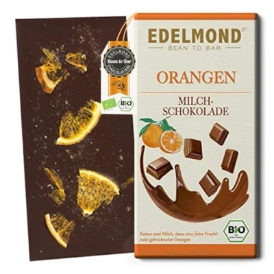 Abbildung von Bio Orangen Milchschokolade Edelmond / Gewalzte Kakaobohnen + luftgetrocknete Fruchtiger Fair Trade Kakao (1 Tafel)