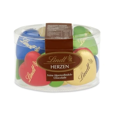 Abbildung von Lindt Schokolade Vollmilch Schokoladenherzen 300 g 15 x feinste Alpenvollmilch in Herzform den Farben Grün, Rot, Blau, Gold Schokoladengeschenk