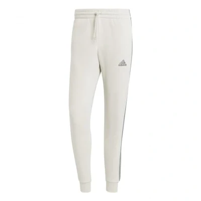 Abbildung von adidas Essentials Fleece Tapered Cuff 3 Stripes Pants, Herren Hose, Alumina,