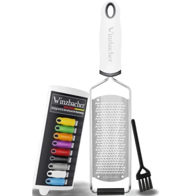 Abbildung von Winzbacher Premium Zester Reibe I Parmesanreibe, Zitronenreibe, Muskatnuss Reibe, Ingwerreibe u.v.m. rasiermesserscharfe Edelstahl Klinge Spülmaschinenfest inkl. Schụtz &amp; Reinigungsbürste