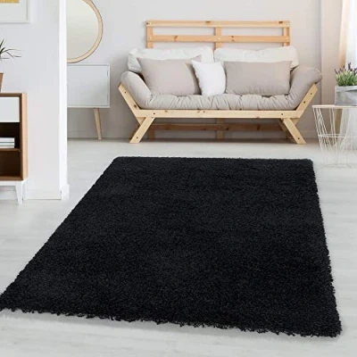 Abbildung von Carpetsale24 Shaggy Hochflor Teppich Wohnzimmer 140 x 200 cm Schwarz Modern Flauschiger Extra Weich, Pflegeleicht und Einfarbig Ideal als für Schlafzimmer, Esszimmer Küche