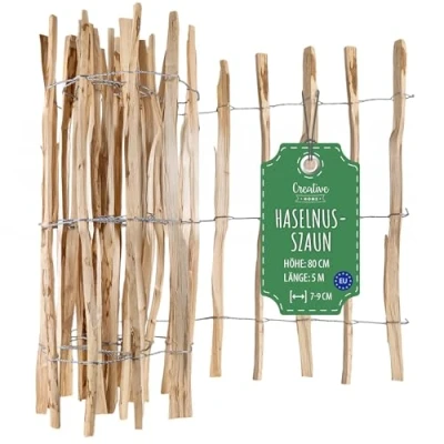 Abbildung von Creative Home Staketenzaun 80cm hoch und 5m lang Haselnusszaun Rollzaun Lattenabstand 7 9 cm Gartenzaun Holz Holzzaun Zaun Garten Ideal als Rasenkante Blumenbeet Umrandung aus Haselnuss