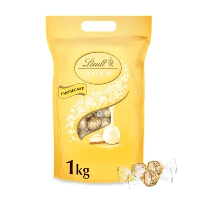 Abbildung von Lindt Schokolade LINDOR Kugeln Cheesecake 1kg Beutel, wiederverschließbar 80 weiße mit zartschmelzender Füllung Pralinen Geschenk Schokoladen