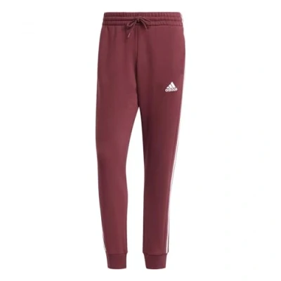 Abbildung von adidas Essentials Fleece Tapered Cuff 3 Stripes Pants, Herren Hose, Tent Green,