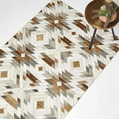 Abbildung von Homescapes Patchwork Teppich geometrisch 90x150 cm, Lederteppich Ethno Muster, Fellteppich braun grau Creme aus Ziegenfell