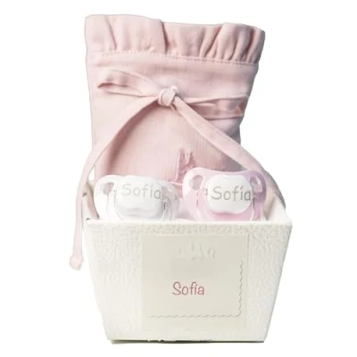 Abbildung von 2 personalisierte Schnuller und Schnullerbeutel Rosa. Wertvolles personalisiertes Geschenk zur Geburt. Präsentiert in einer sehr eleganten Schachtel.